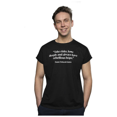 Model wearing black Bowelbabe Fund loose t-shirt. White text print reads "Take risks, love deeply and always have rebellious hope" - Deborah James