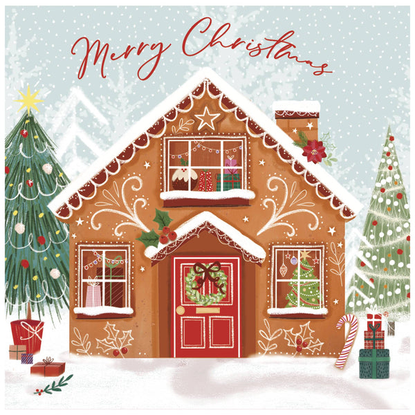 A Christmas card of a gingerbread house decorated with icing, a red door with a wreath, and windows displaying ornaments and presents. Two Christmas trees stand on either side—one with colourful ornaments and the other with white lights. Snow covers the ground, with wrapped gifts scattered around. The text 'Merry Christmas' appears at the top in red cursive.