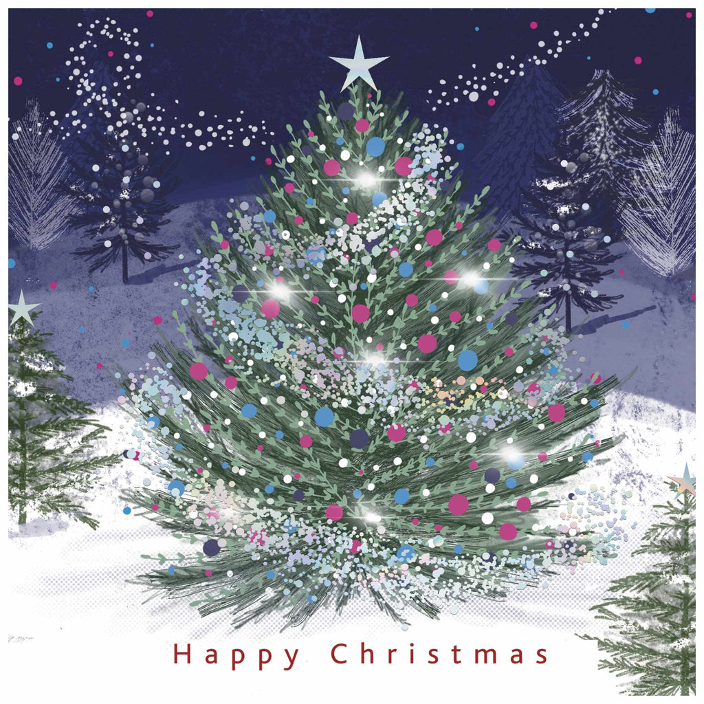 A Christmas card of a decorated Christmas tree with colourful ornaments and lights, set in a snowy outdoor scene. The background includes other trees and a night sky with falling snowflakes. The text 'Happy Christmas' appears at the bottom.