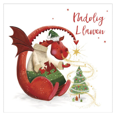 Christmas card with a dragon holding a Christmas stocking and a tree, featuring the Welsh greeting 'Nadolig Llawen'.