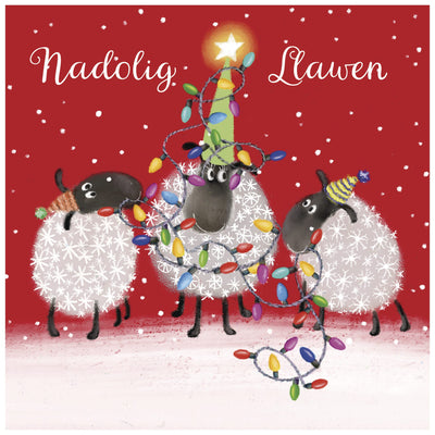 Three sheep wrapped in Christmas lights on a red background with 'Nadolig Llawen' text.