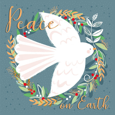 A traditional, peace-themed charity Christmas card featuring a white dove centred within a leafy wreath with red berries, on a muted blue-grey background.