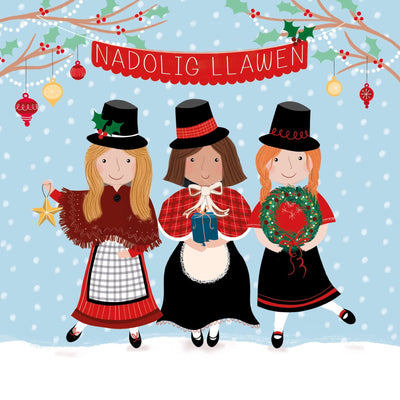 Welsh speaking charity Christmas card by Cancer Research UK. The design features a festive illustrated Christmas scene with three children in traditional traditional clothing standing in the snow under a red banner that reads 'NADOLIG LLAWEN.' 