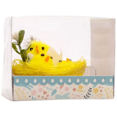 A box with Easter chicks hatching in a nest. Chicks and nest are yellow.