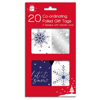 A retail package of 20 co-ordinating foiled gift tags featuring four winter-themed designs with metallic finishes: navy blue snowflakes, white snowflakes, silver stars, and a navy and white 'let it snow' design. The package is bright red with white text.