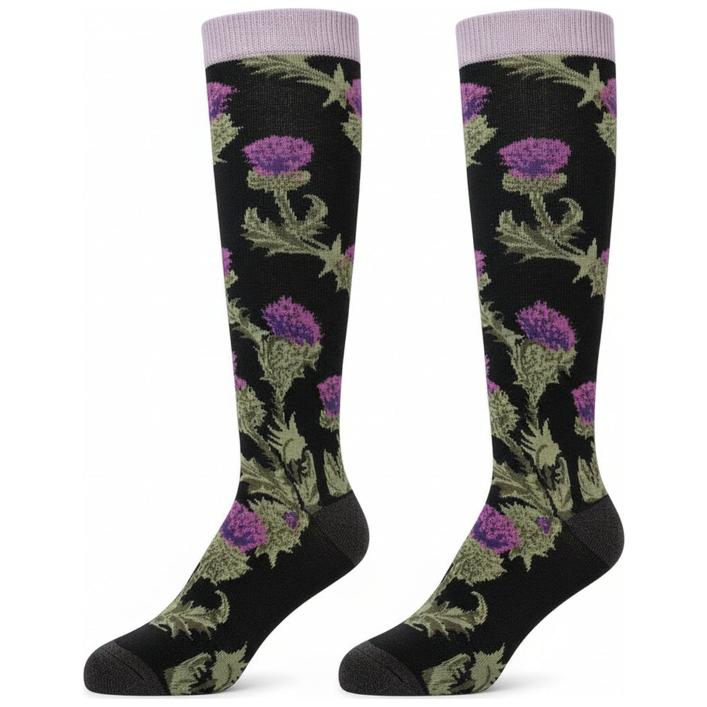 A pair of warm adult wellington boot socks with a floral thistle design. The base colour of the socks is a dark blue, with the top featuring a lilac coloured band.