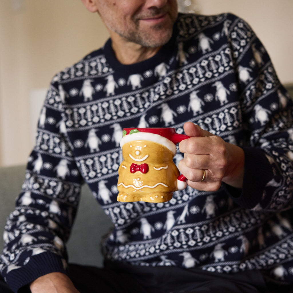 Man sips from his Gingerbread Christmas Mug