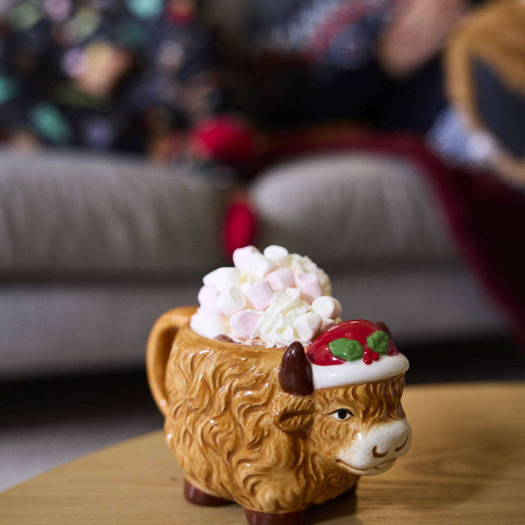 Highland Cow Christmas Mug is filled with hot chocolate and marshmallows.