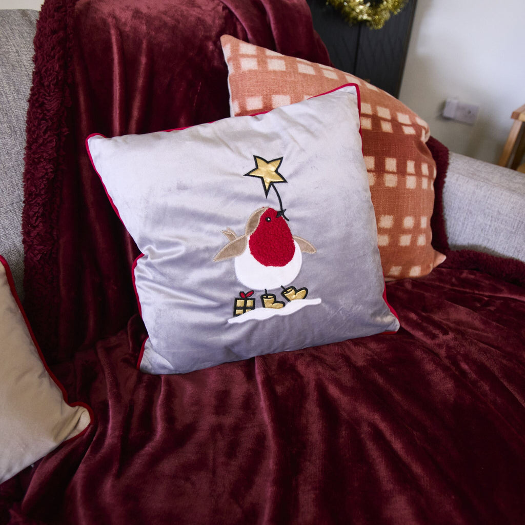 Robin Applique cushion on a sofa. The perfect decorative cushion for Christmas time.