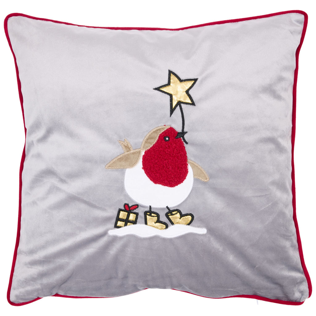Applique robin cushion featuring a robin holding a golden star in its beak. The robin is standing in snow, with a golden present behind.