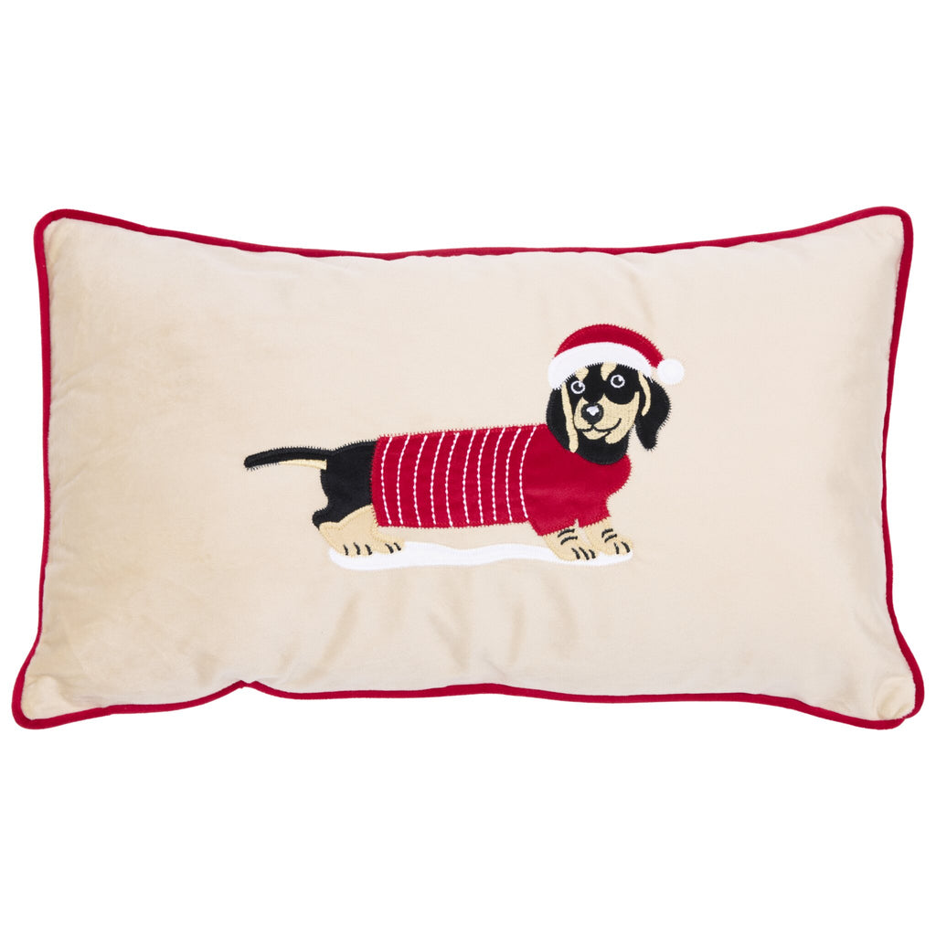 Dachshund cushion with a beige background and red piping around the edges, featuring an embroidered black and tan dachshund wearing a red sweater with white stripes and a red Santa hat.