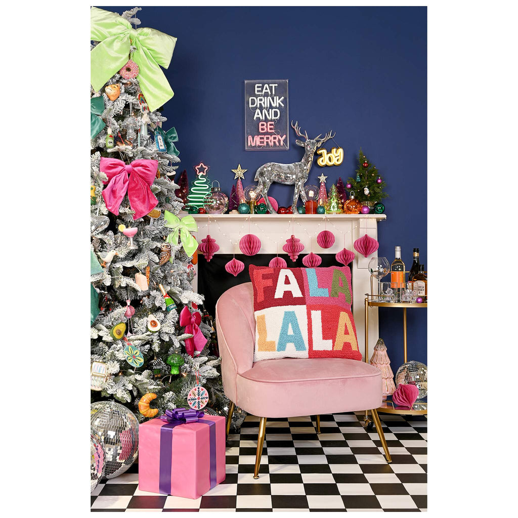 Square Christmas cushion featuring FA LA LA LA design. in a home environment. A perfect piece of Christmas decor 