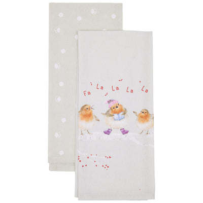 Two white kitchen tea towels stacked on a white background. The front towel features a winter illustration of three fluffy robins with red 'Fa La La La La' text above them, and the back towel has white polka dots.