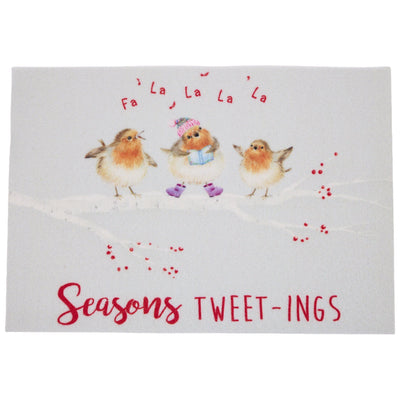 A rectangular doormat featuring three painted robin birds on a snowy branch. The centre bird wears a pink hat and purple boots, with red text above reading 'Fa La La La La' and large red text below reading 'Seasons TWEET-INGS'.