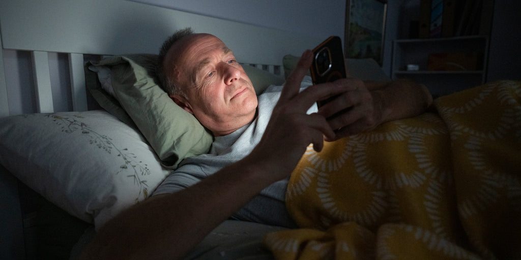 Man reads the cancer chat forums in his bed.