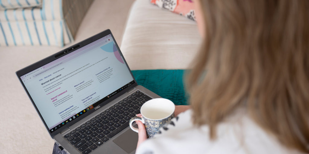 Women reads an article from Cancer Research UK about being worried about cancer.