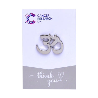 Silver Om wedding favour on a backing card featuring the Cancer Research UK logo and a thank-you message.