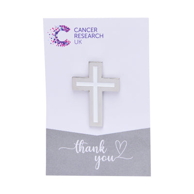 Silver Christian cross wedding favour on a backing card featuring the Cancer Research UK logo and a thank-you message.