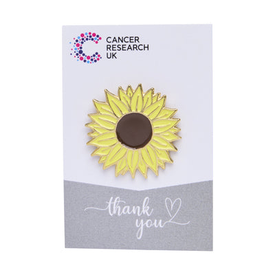 Sunflower wedding favour on a backing card featuring the Cancer Research UK logo and a thank-you message.