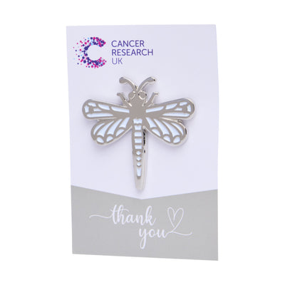 Dragonfly wedding favour on a backing card featuring the Cancer Research UK logo and a thank-you message.