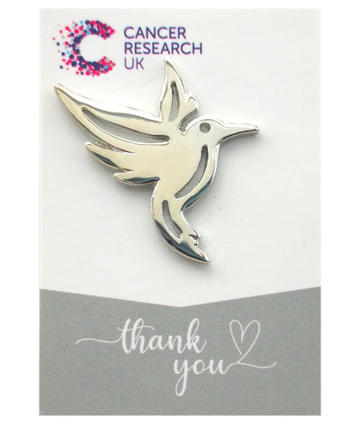 A hummingbird wedding favour pin badge symbolising joy, positivity and good luck, making it a beautiful and meaningful keepsake for your special day.