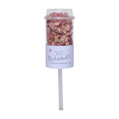 Wedding confetti pop filled with dried petals on a white stick, with a label reading “Will you be my Bridesmaid?”